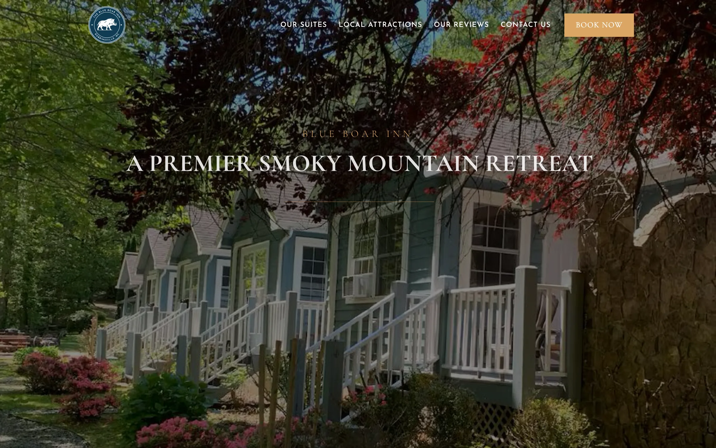 The original Blue Boar Inn homepage: a photo of the inn behind the headline A Premier Smoky Mountain Retreat, a single Book Now button, and menu links labelled Our Suites, Local Attractions, Our Reviews and Contact Us.